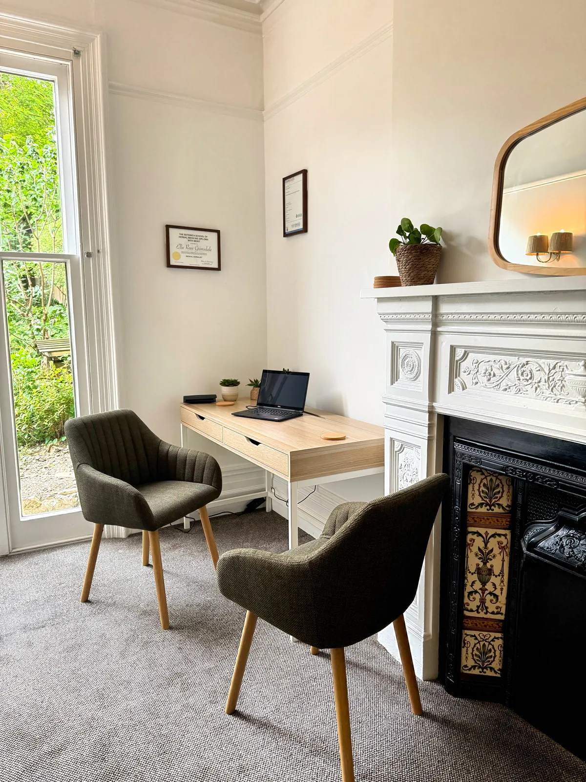 The calm consultation room at the Berkhamsted clinic, with a fireplace and armchairs beside a window